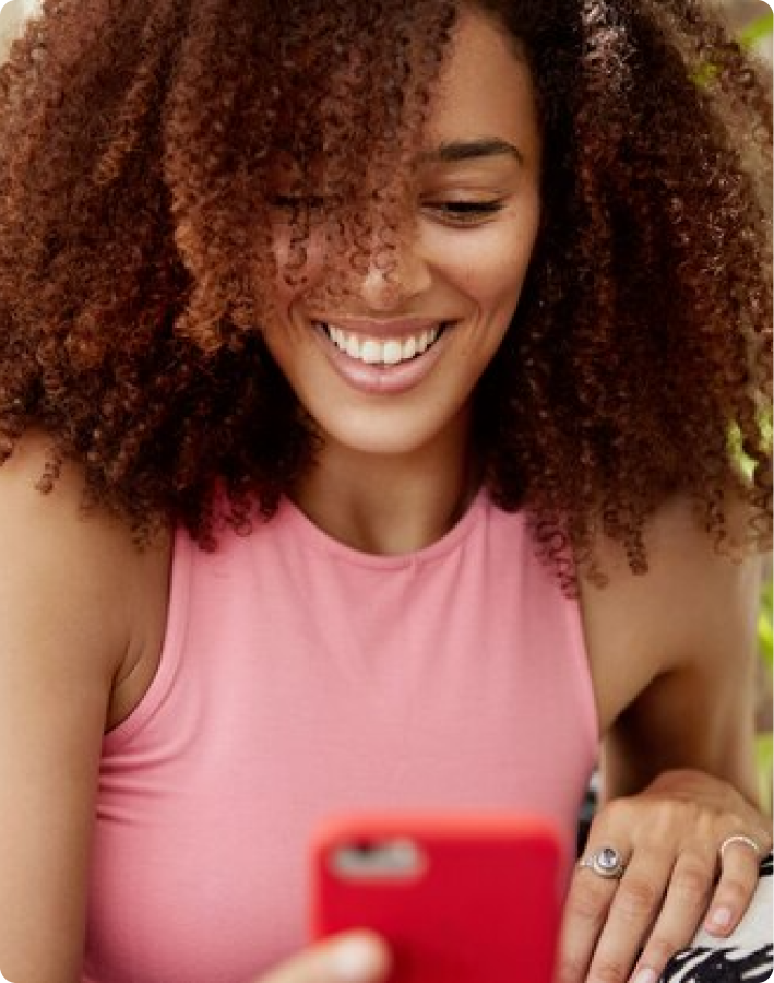 Picture of a lady smiling into her phone